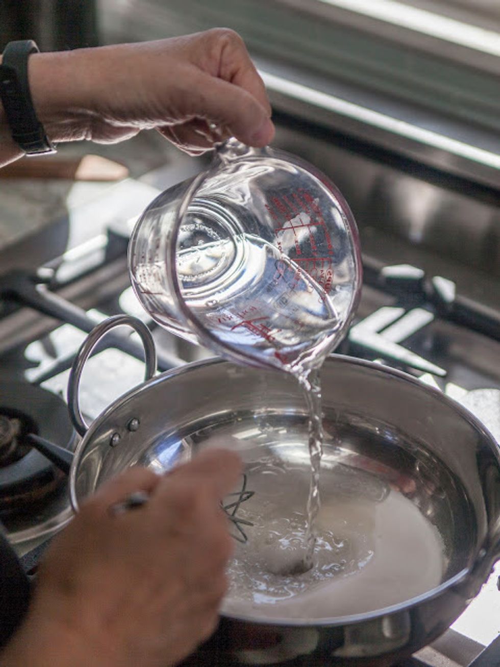 When they are done, remove them from the oven and set them aside. Fill a pan or kadhai with 1 cup of water and 3/4 cup sugar.