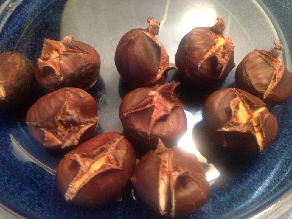 When they're done roasting, remove them from the oven and allow them to cool for a few minutes, 2-3. Do not turn off the oven. Simply turn it down to 350 in case you have to reheat chestnuts to peel.