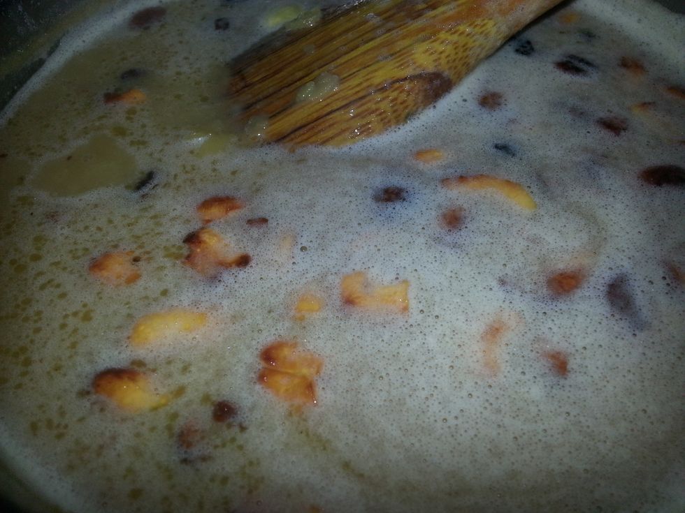 When they turn golden brown, dunk the entire thing into the prepared payasam.