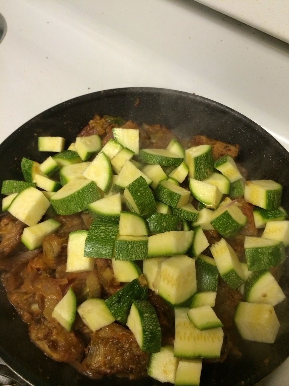When things are mixed...it's time for the zucchini. Mix in the zucchini.