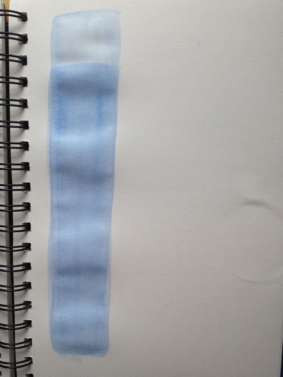 WHEN THIS DRIES, layer a second strip leaving a section at the top as the original strip of blue. Notice the difference between the two blues? Layering can be more effective than adding another color.