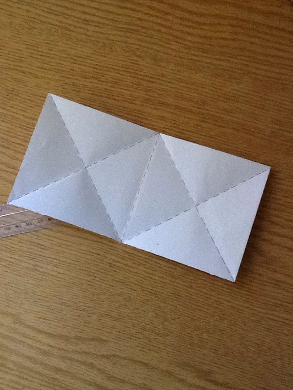 When unfolded you should have a piece of paper shaped like a big rectangle divided into two equal squares.. Each square is devised into 4 triangles..