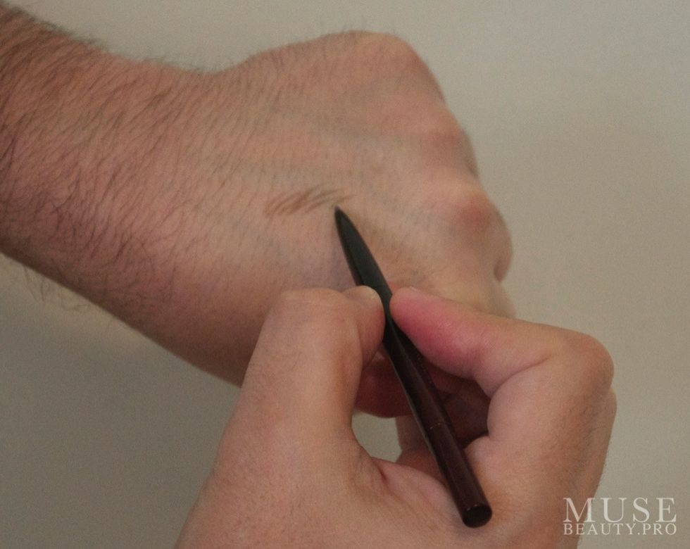 When using the brow pencil draw individual hairs. The fine tip of the pencil allows for very precise markings.