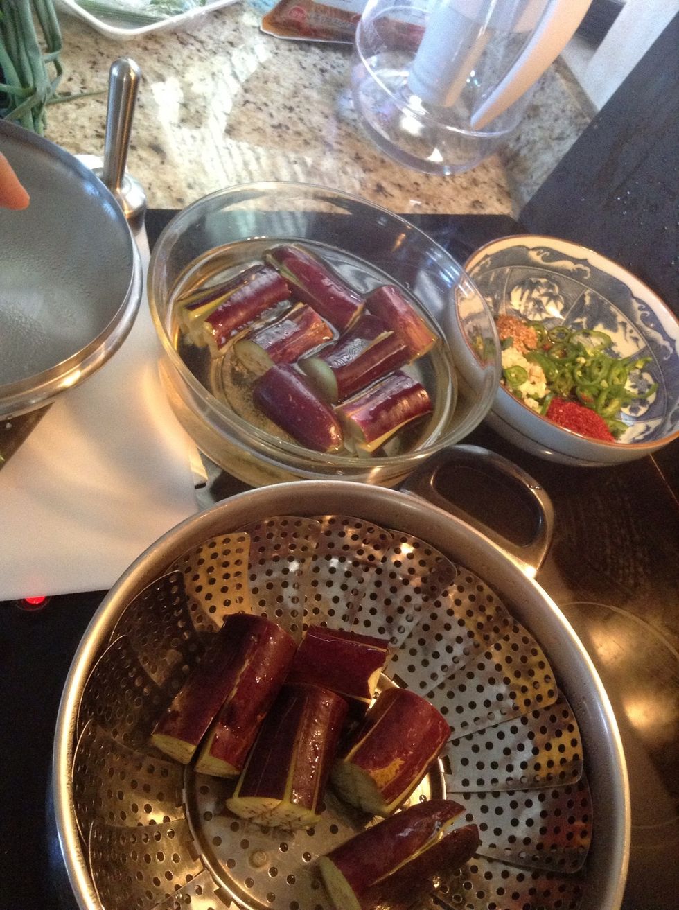 When water is boiling, add eggplants and steam for five minutes.