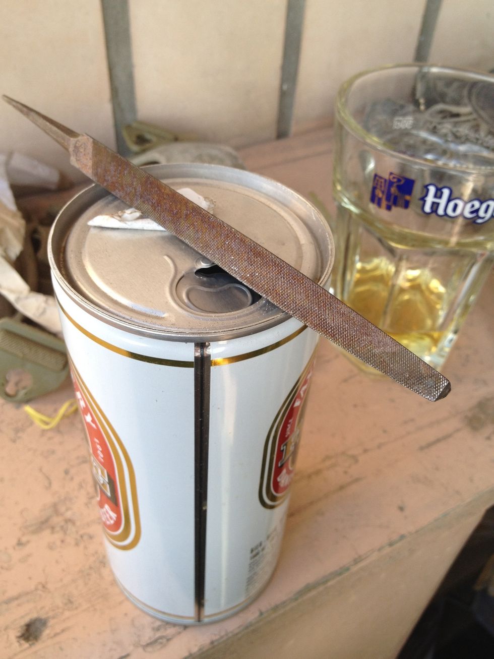 When we are finished and a little drunk, we take a file and apply it to the upper rim of our can.
