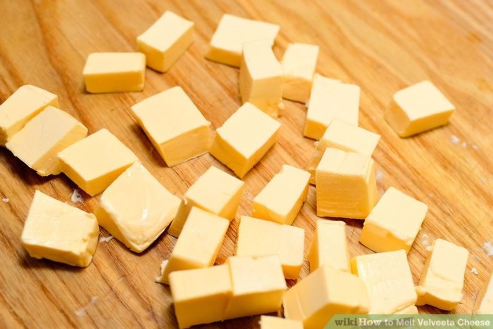 When you are done then cut your velveeta into squares and put them in the pan  with your noodles