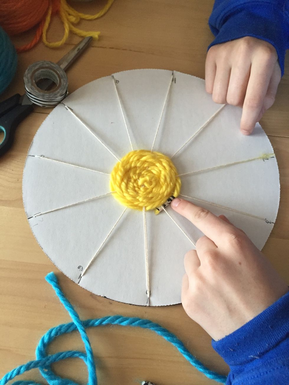 When you are done with your first color, tuck the taped end under your weaving.