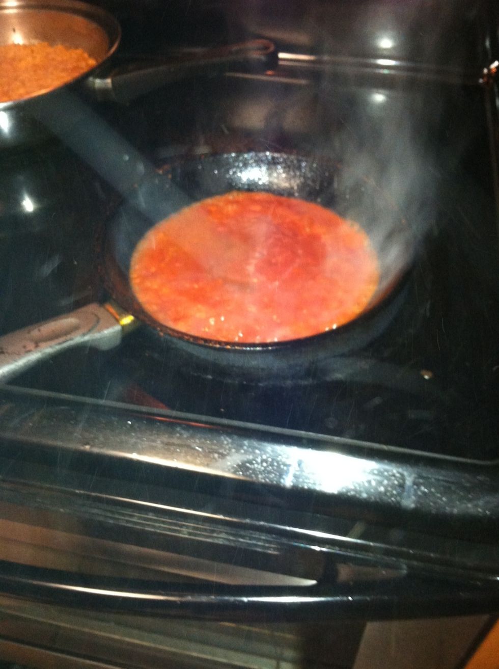 When you are finished frying your tortillas, on the same pan, pour tomato sauce, careful it pops!!
