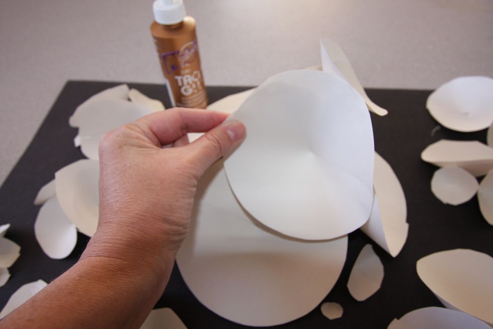 When you are happy with arrangement, use tacky glue to adhere pieces to each other and to the background. Lay flat to dry completely.