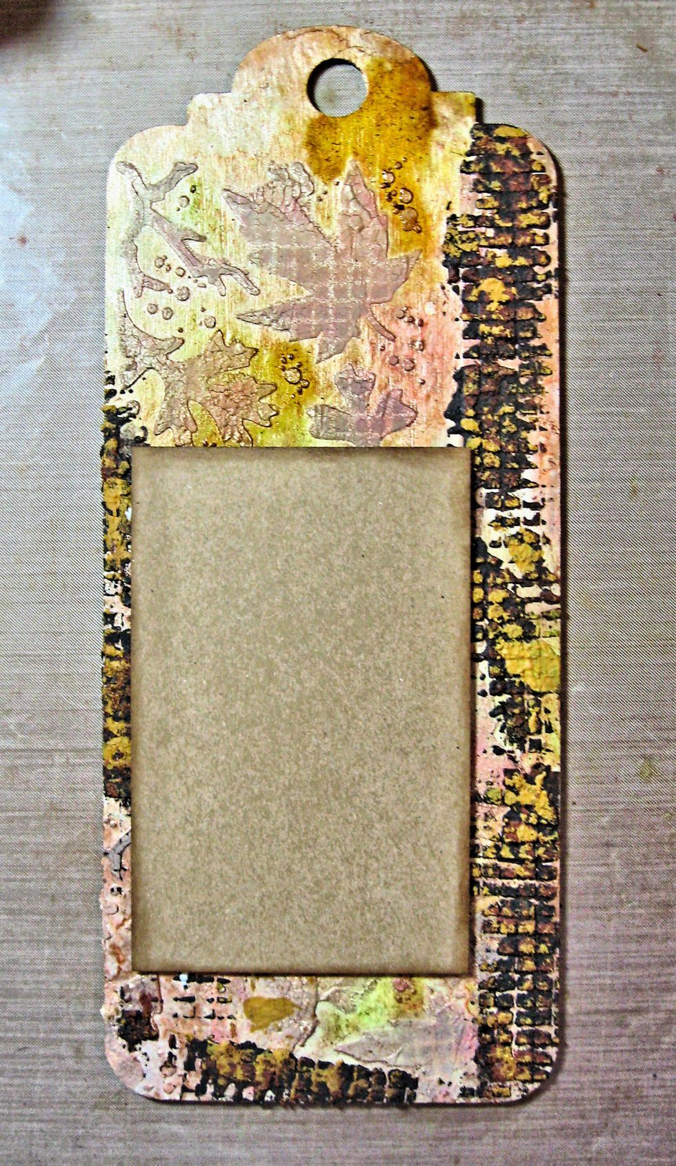 When you are happy with the colors, begin adding the paper layers. No two tags are exactly alike. The important thing to remember is to dry each layer of ink, stain or paint so you don't get mud.