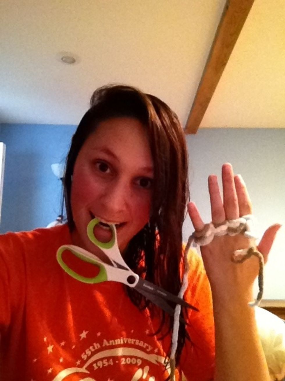When you are happy with the length of your scarf, cut the yarn several inches down... don't actually use your teeth to grip the scissors!!