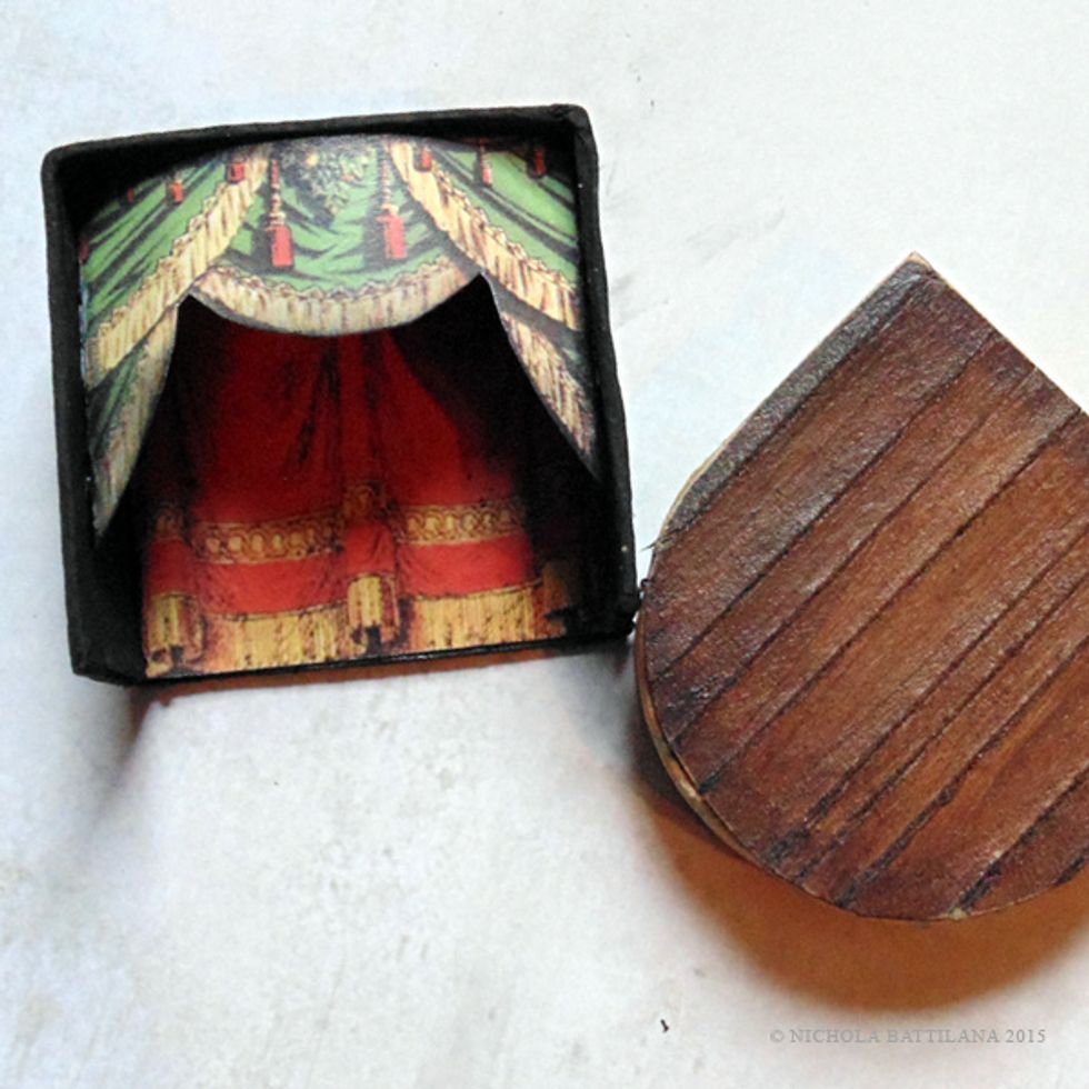 When you are satisfied with the look of your set, affix the top of the stage to the bottom floor.