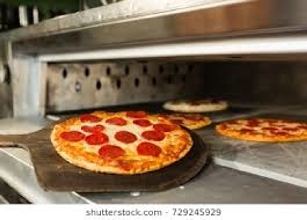 When you come back take the pizza out of the pizza oven all the cheese should be mixed together. When you take the pizza out put it on a plate {that is bigger then the pizza}