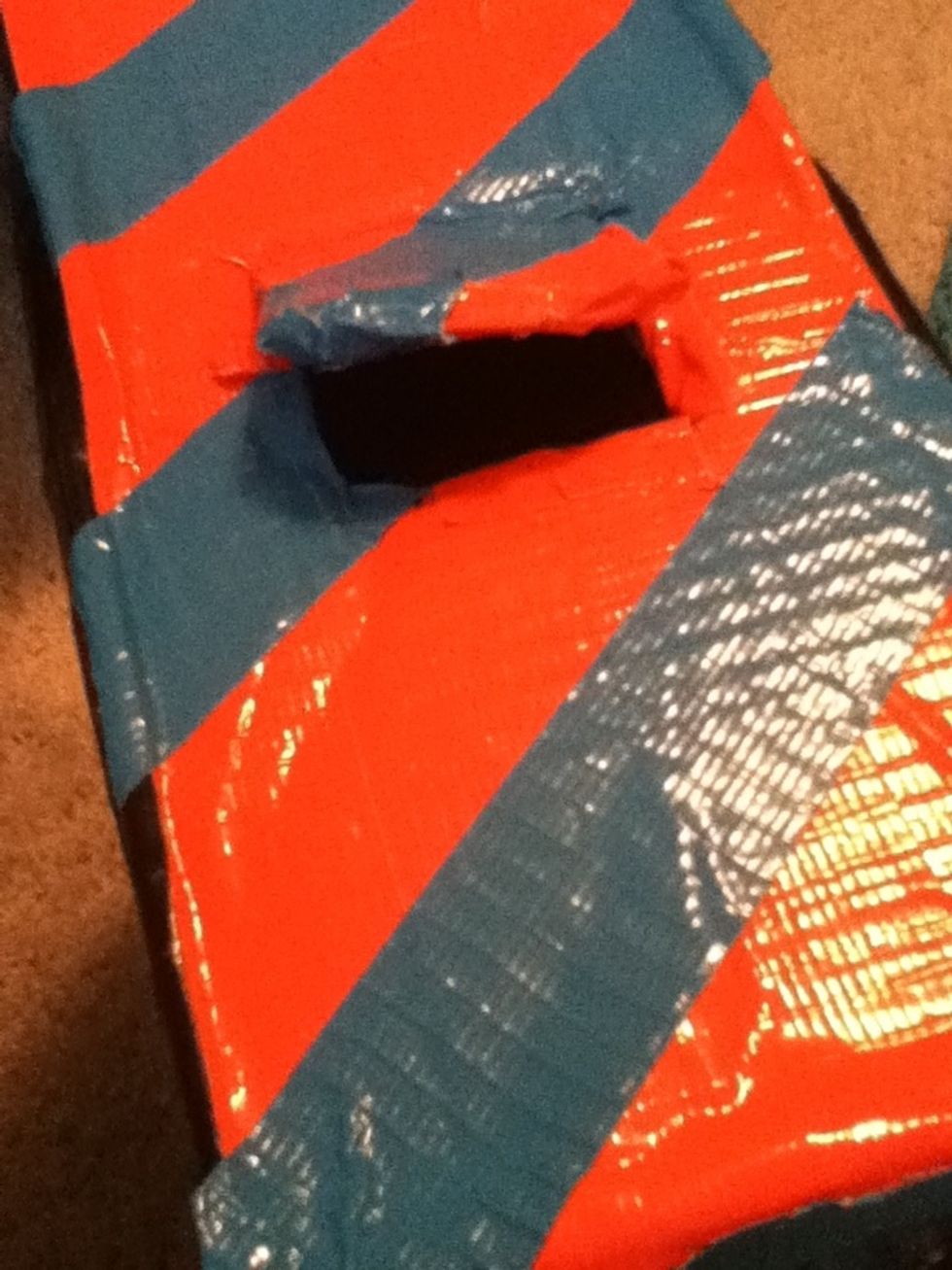 When you find a good spot, make a hole big enough for the candy or streamers. (You can tape the edges of the hole if you don't want cardboard to stick out.)