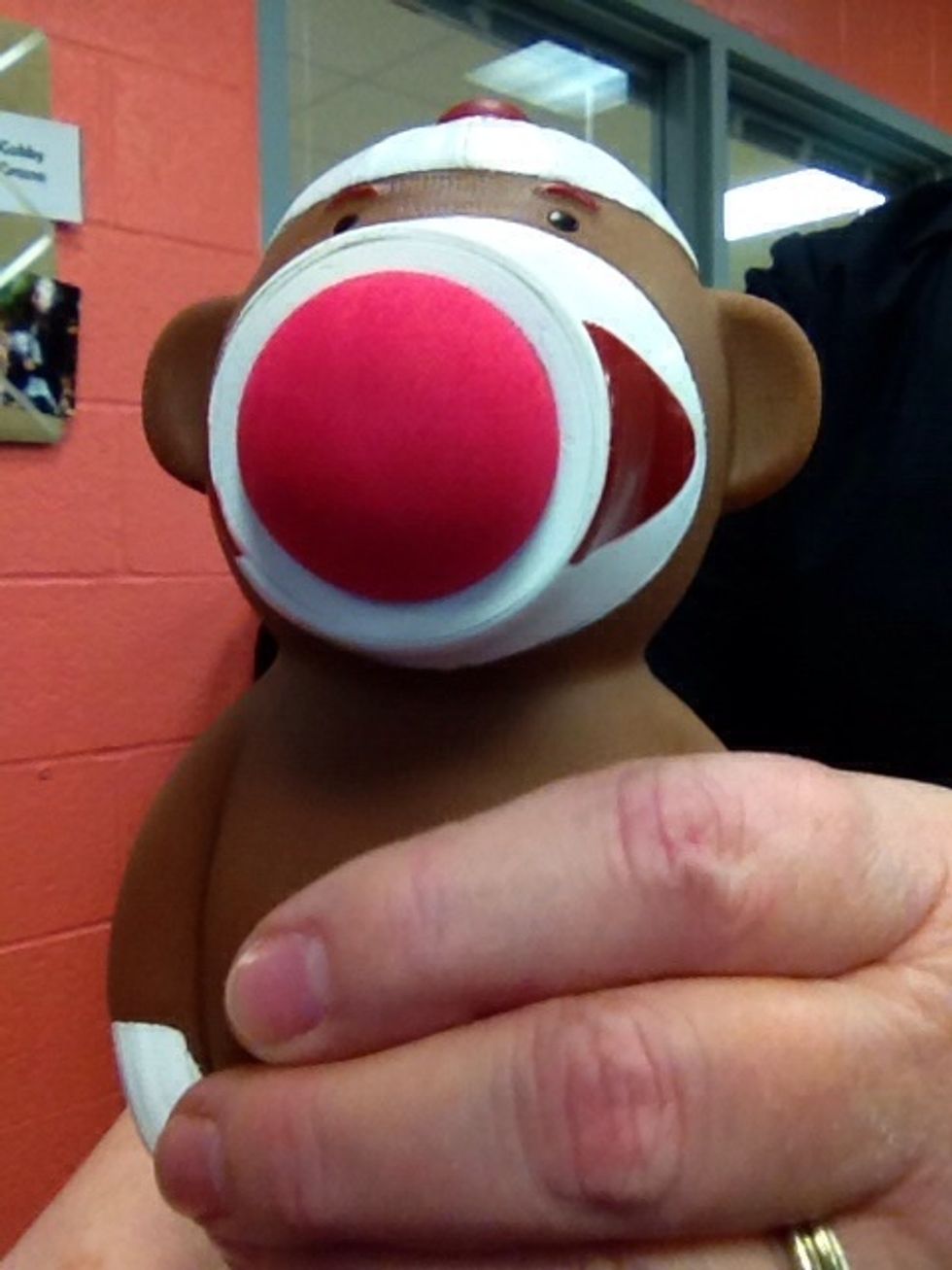 When you find a sleeping student, firmly grasp the sock monkey popper around the middle.