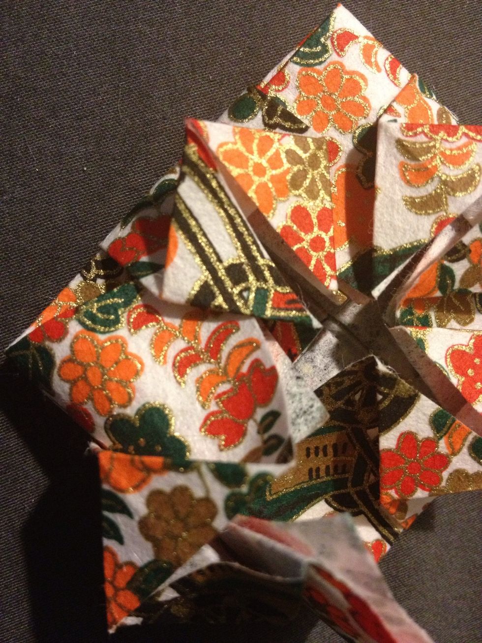 When you fold it down, make the corners of the paper go under the diamonds so it is hidden
