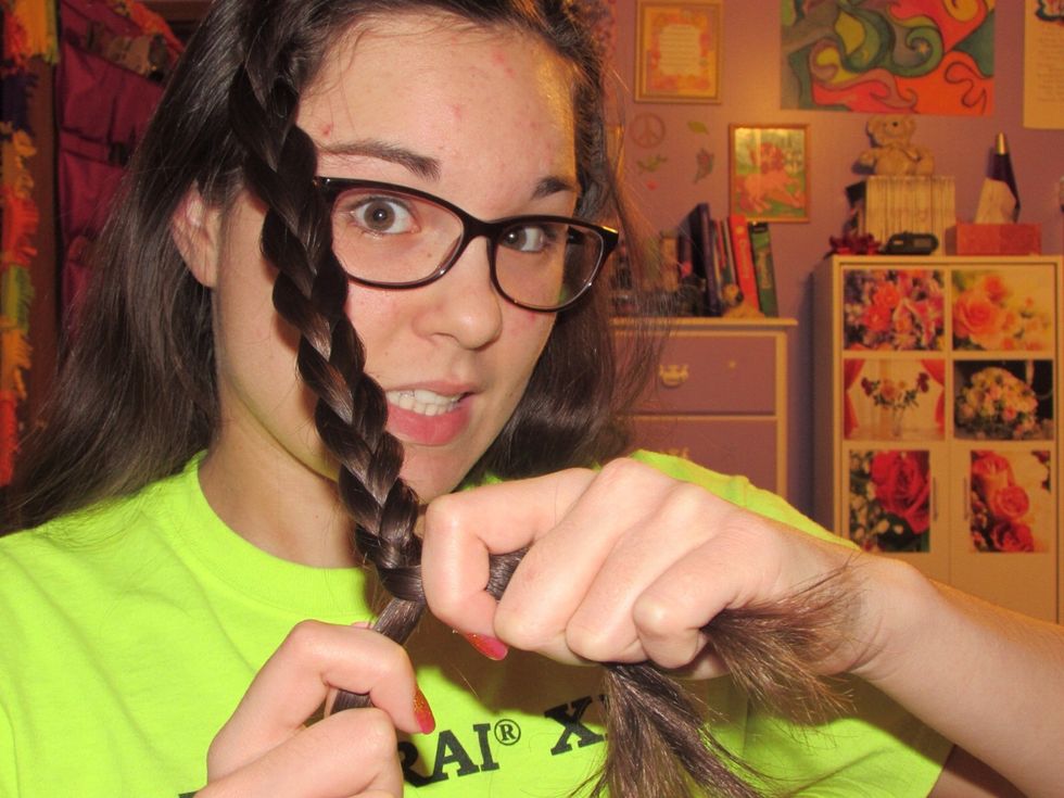 When you get down to the length you like, take one of the strands, hold it in one hand, and take the other two and hold them in your other hand.