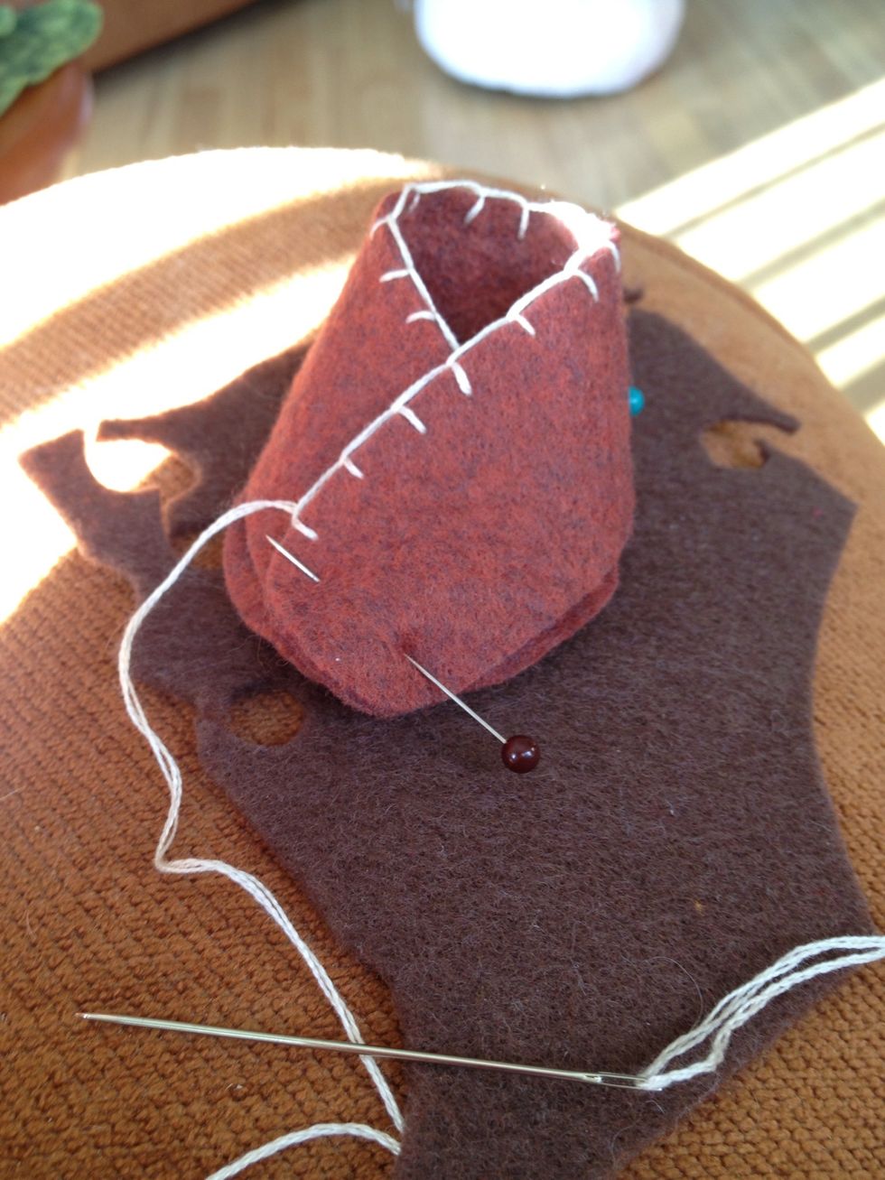 When you get to the end of the top of the slipper, wrap, and pin to the sole.