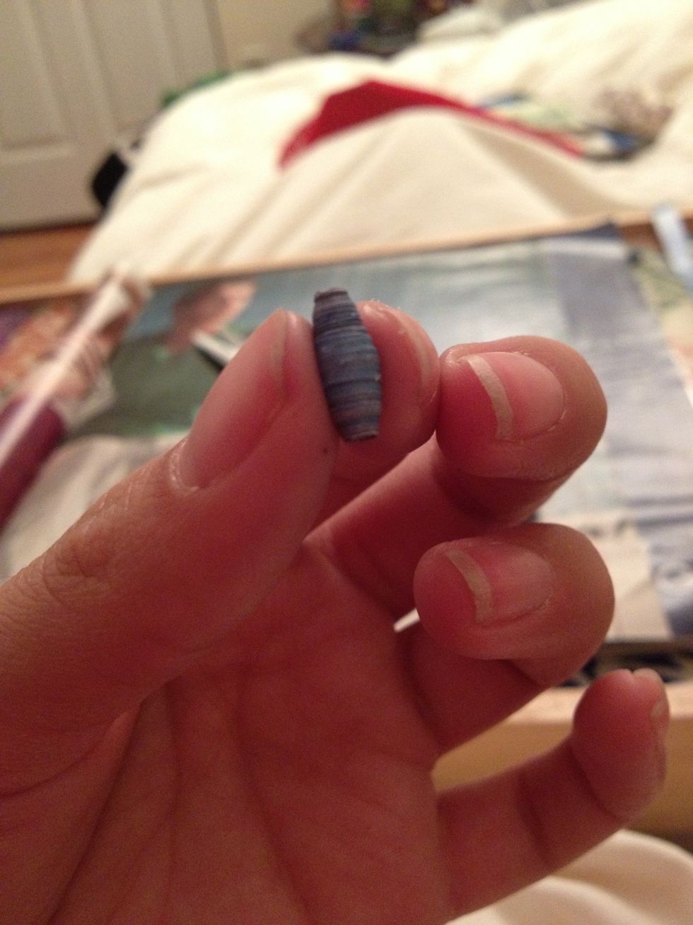 When you get to the end of your triangle, apply some glue. I put the glue under the last little piece AND over it. Roll 'em all- or until you get sick of 'em.
