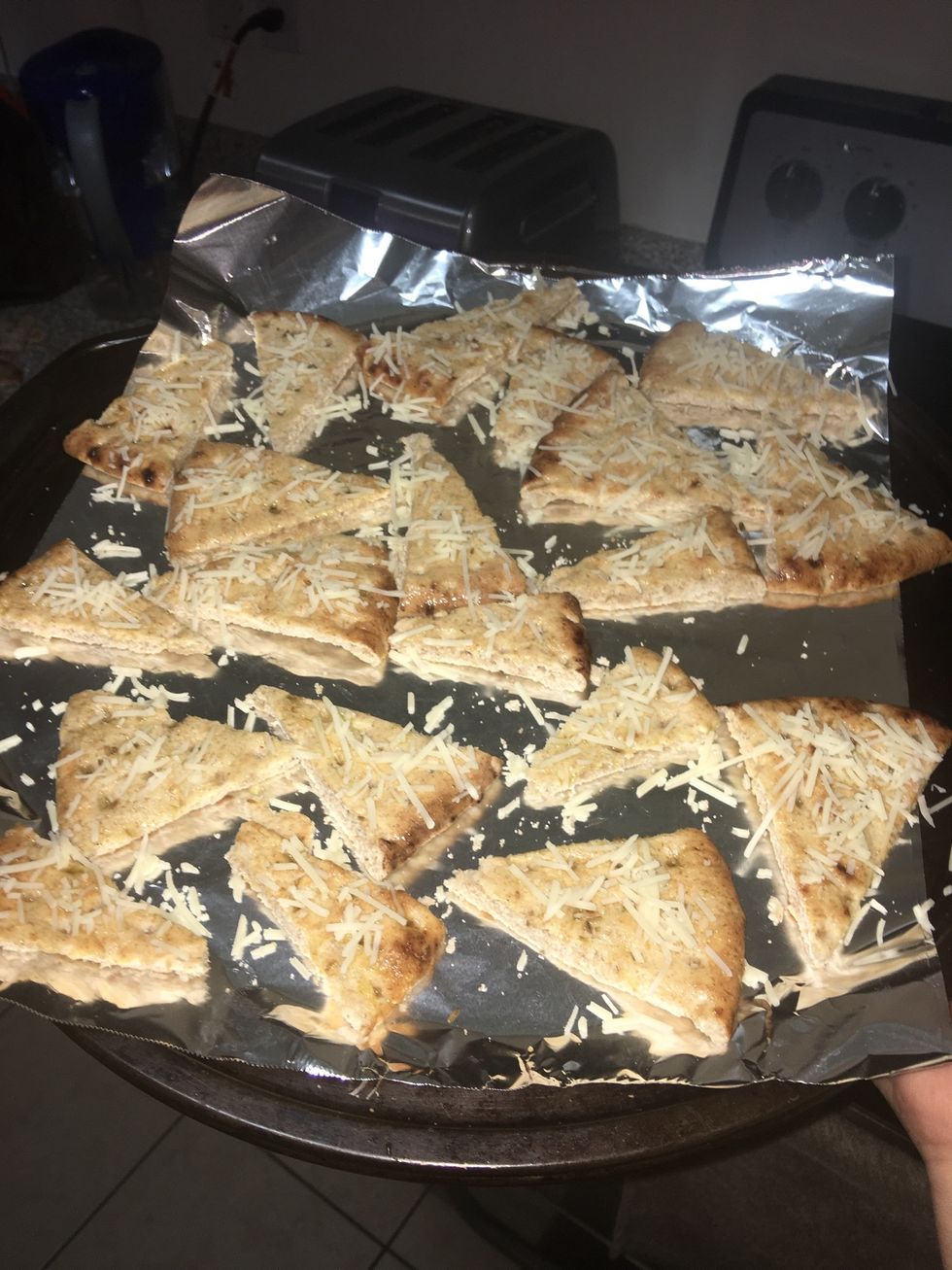 When you have applied the mixture add a sprinkle of parmesan cheese onto each slice.