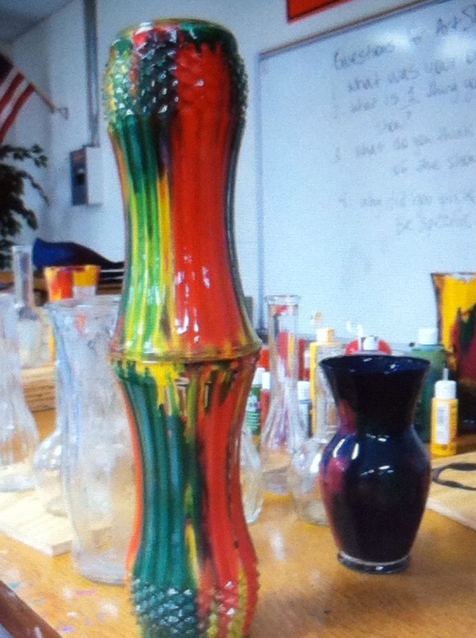 When you have coated the vase, turn it upside down on top if another vase and let the paint run out into the next vase.