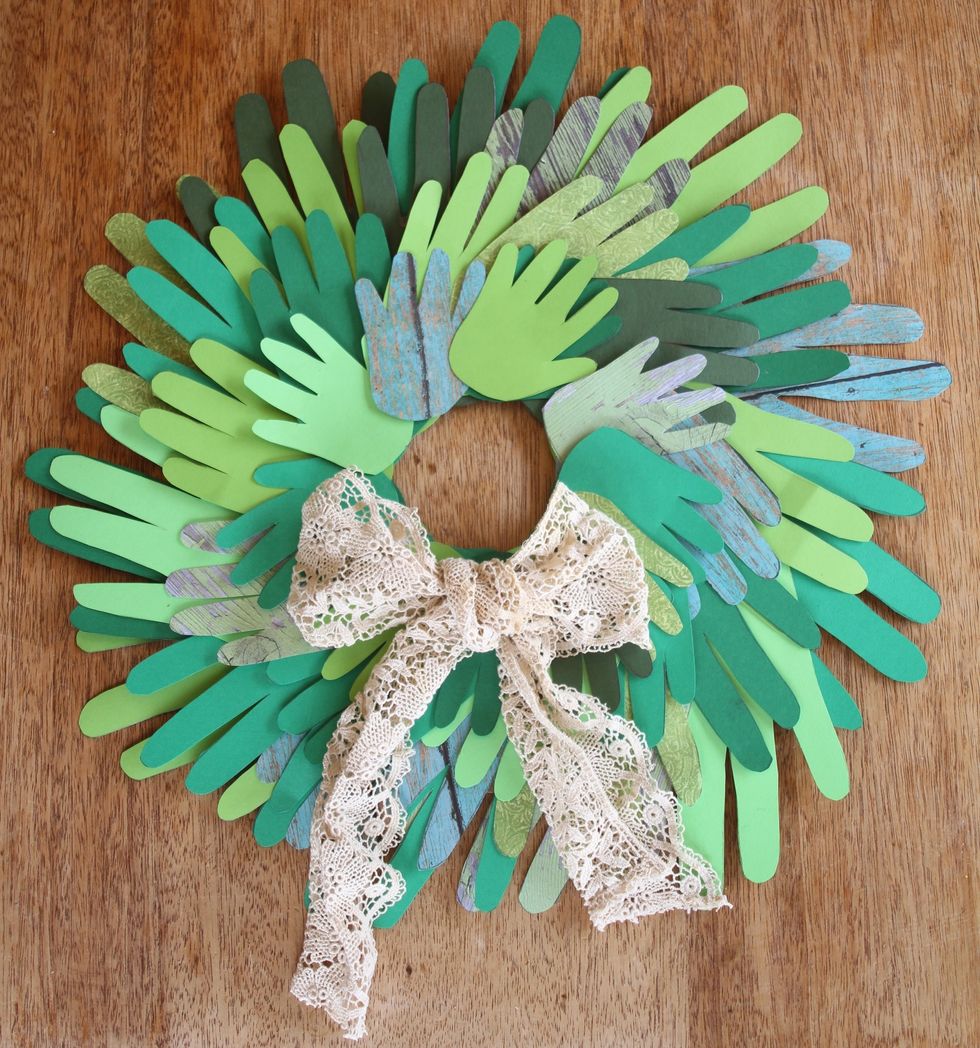 When you have glued all of the hands, adorn with a tea stained ribbon, paper berries, glitter, or really anything jazzy you have in your craft arsenal.