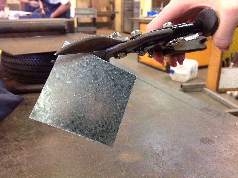 When you have marked your circle, you use the tin snips to carefully cut around it.