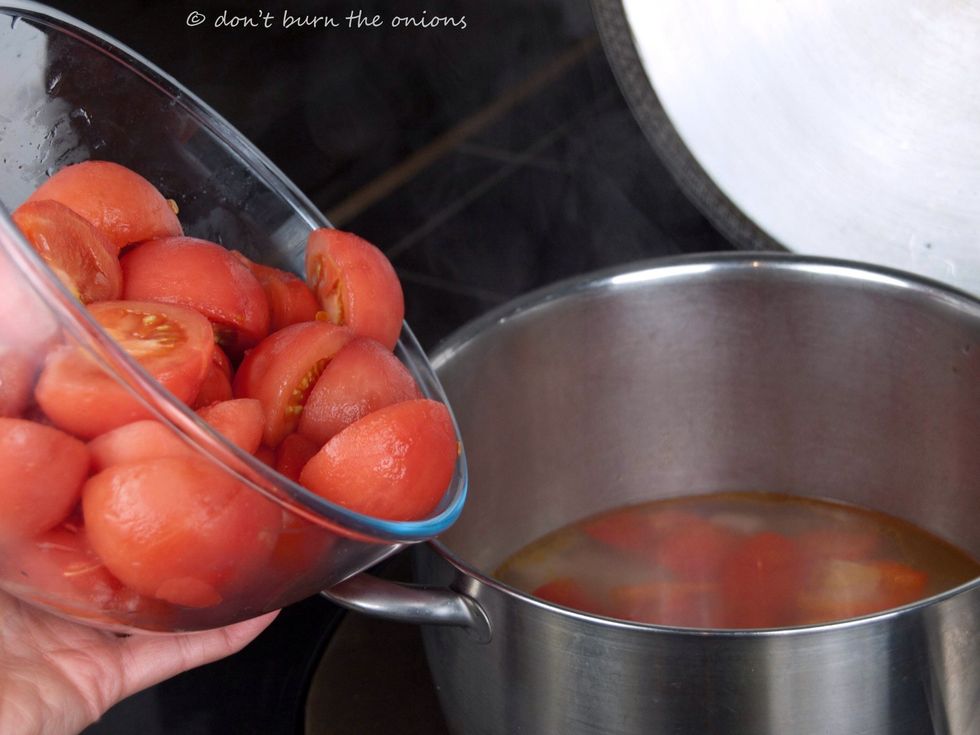 When you have peeled all the tomatoes, chop them in half and add to the rest of the vegetables. If not very ripe tomatoes you can add a little powdered stock for more flavour. (About 1 teaspoon)