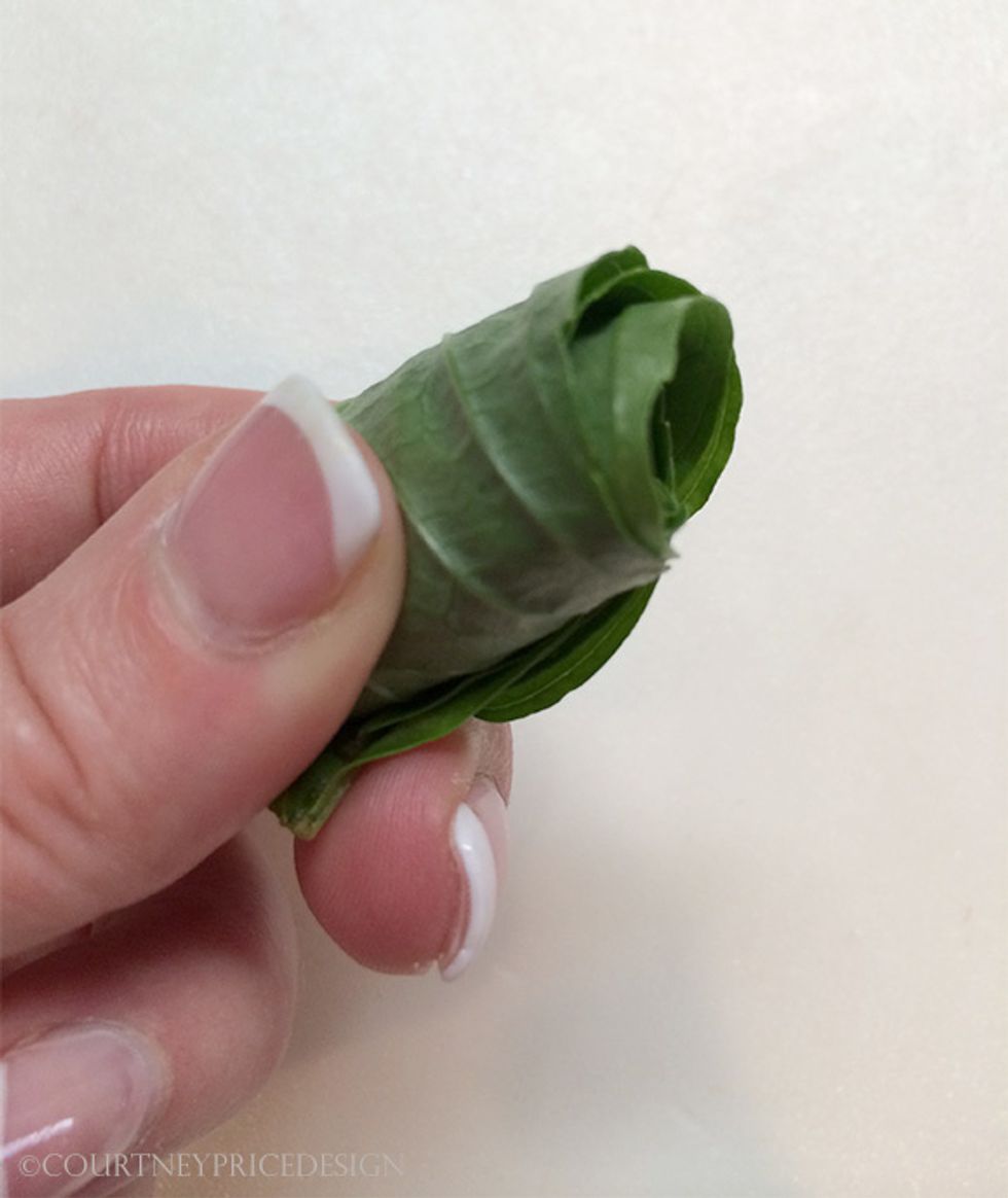 When you have the stack rolled, place it gently on your cutting board with the bottom of the leaves down(to keep roll in tact), slice thinly from right to left. Watch your fingers!