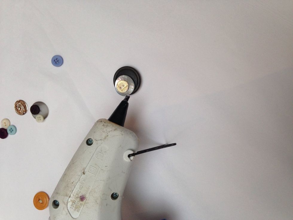 When you have your design, first glue the buttons together starting with the biggest down to the smallest.
