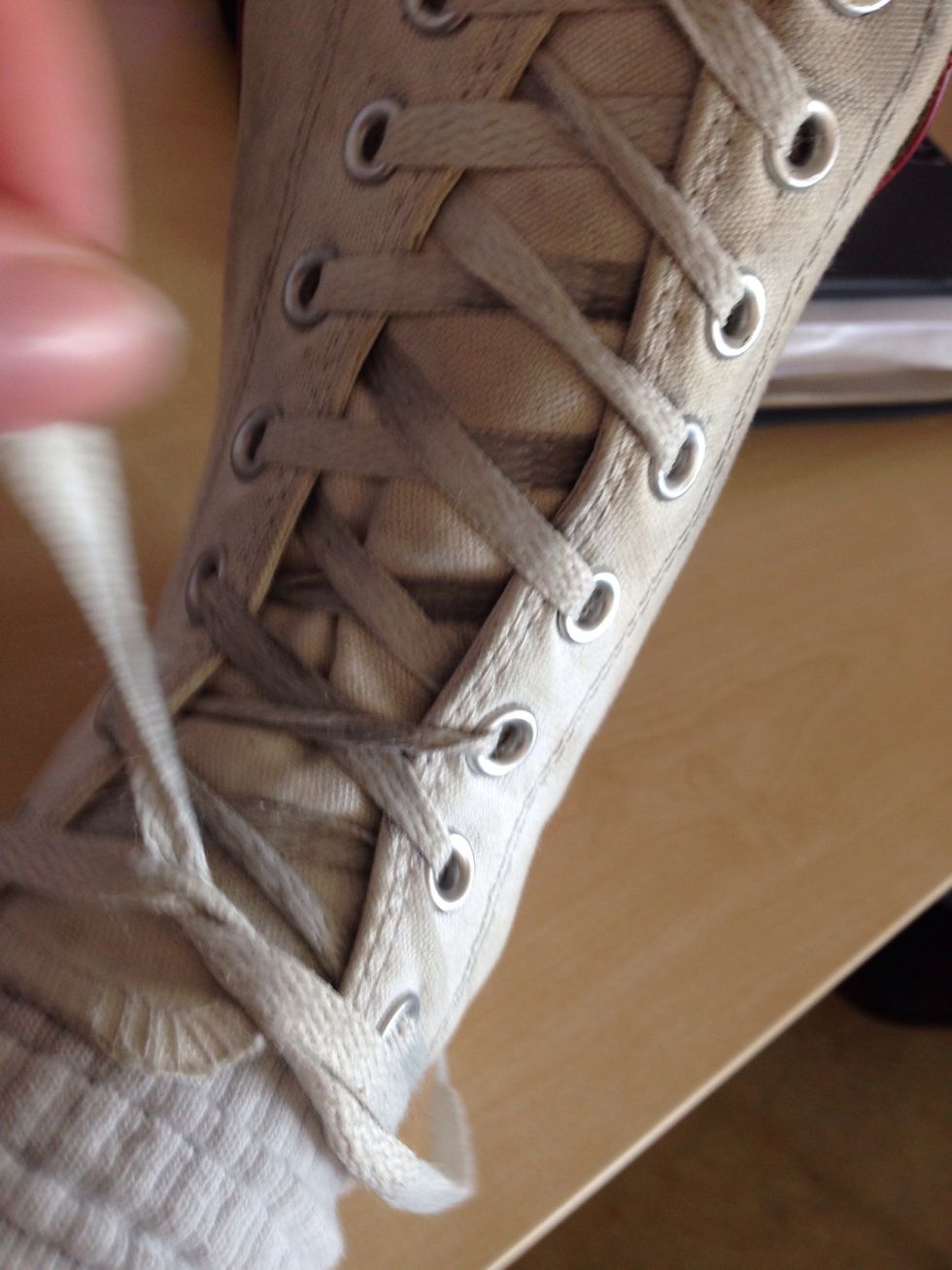 When you have your laces pulled tight and you feel ready to tie them, take one of the laces and put it first under the other, then over and then under agiain, and then pull hard