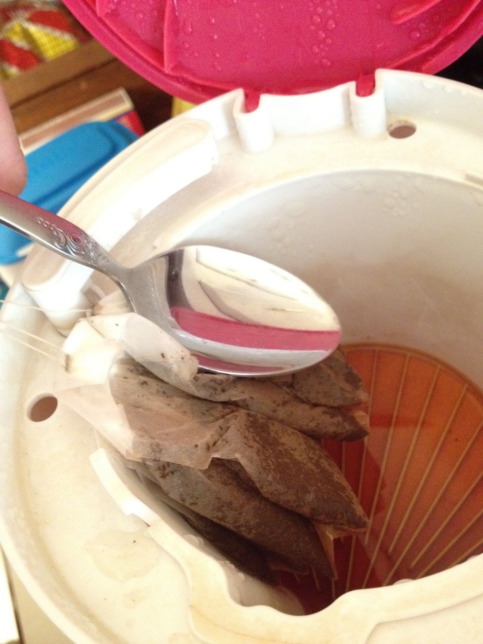 When you lift the lid be careful of the rising steam, it will burn you! Use a spoon and press the remaining brewed tea out of the tea bags. Discard old tea bags in the garbage or compost.