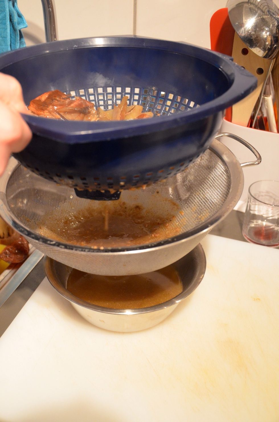 When you like the consistency of the gravy sieve it through whatever you have at hand.