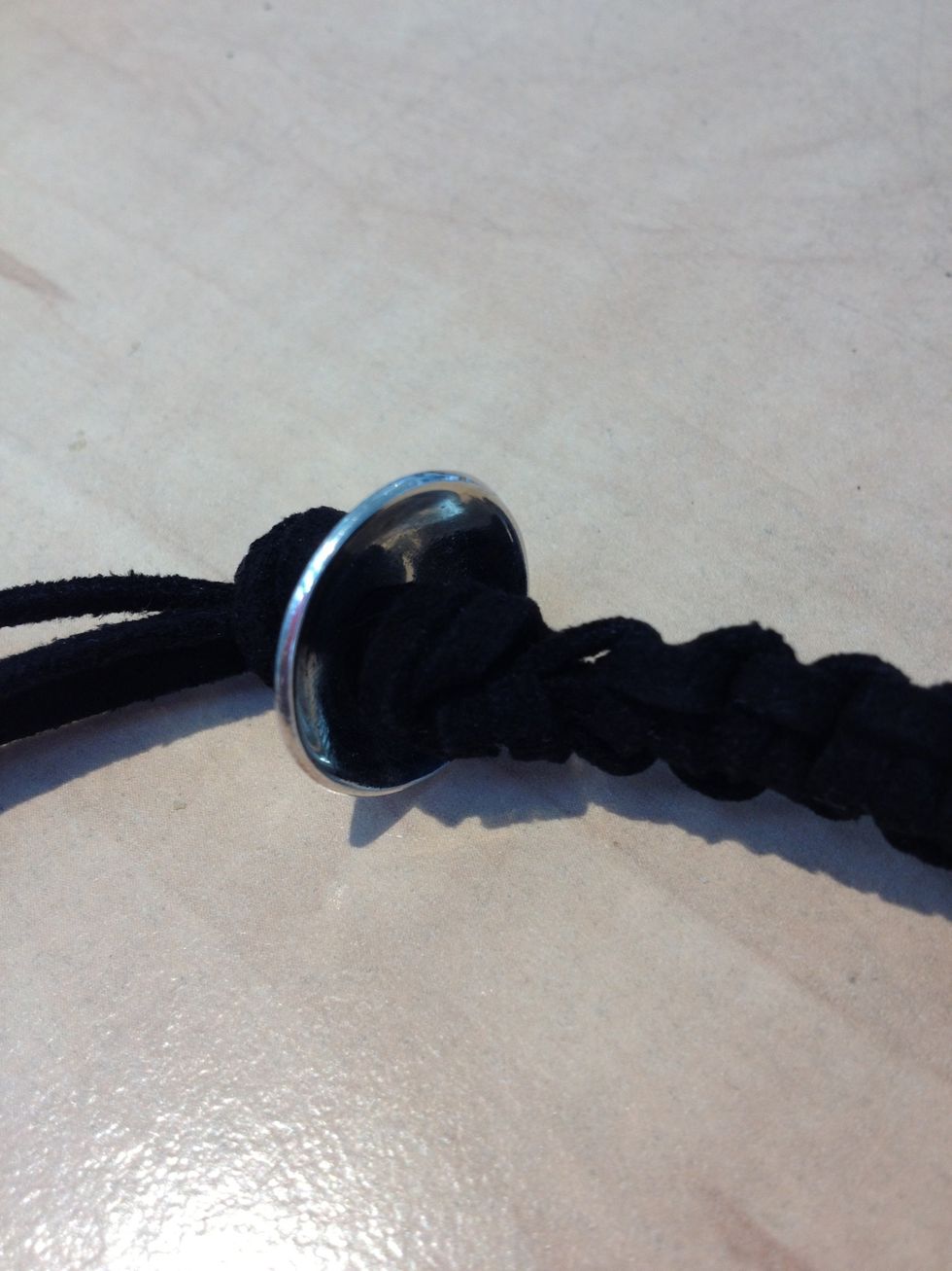 When you're done, make a big knot. Put the toggle on the thongs and make another big knot. Cut the rest of the thongs off.