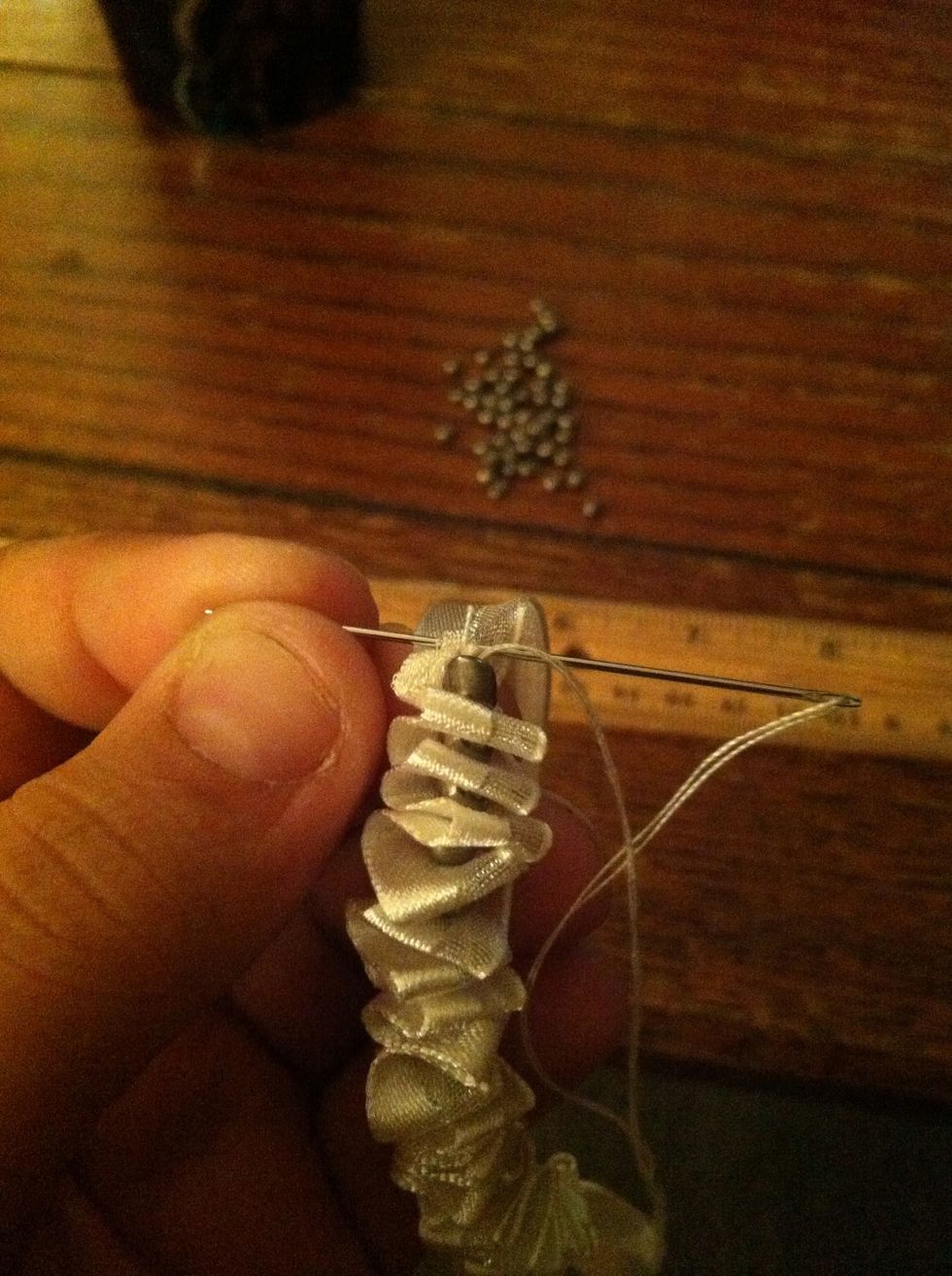When you reach the first bead again, go through the ribbon and back in, pull it all snug.