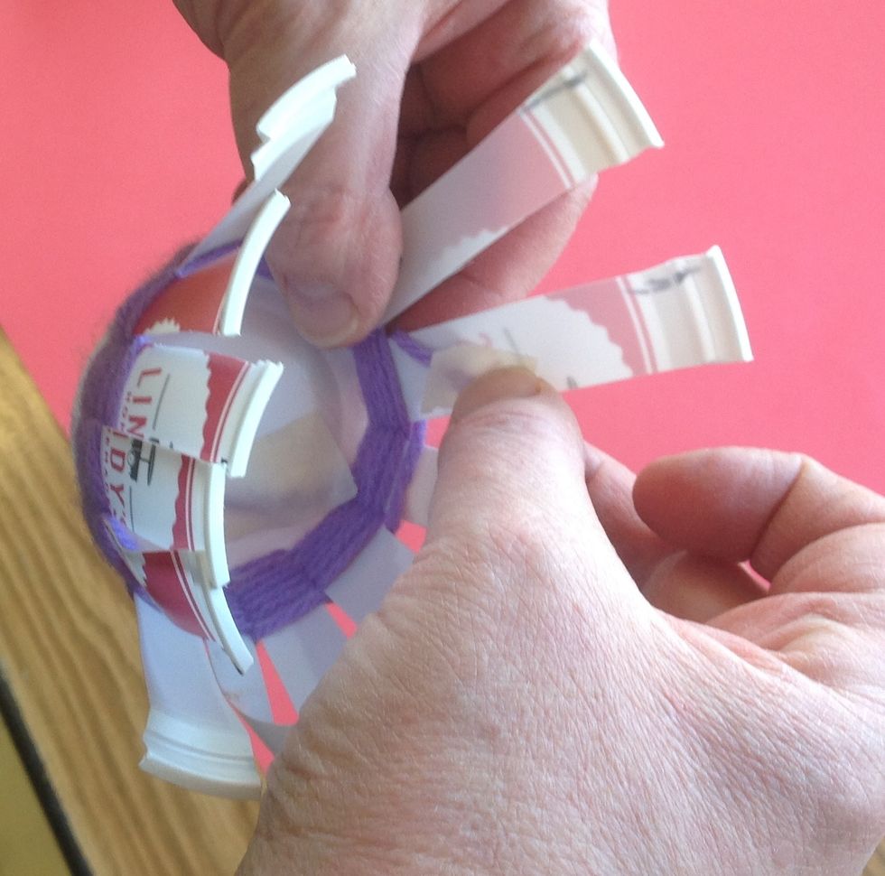 When you run out of yarn or need to change color, tape the yarn to the back of the warp.