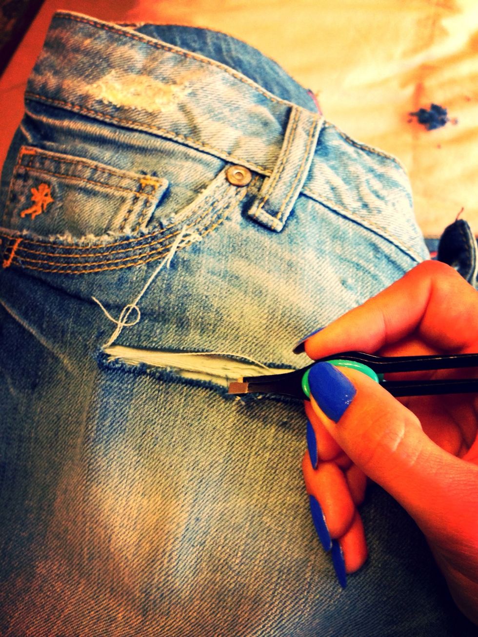 When you see the white strings begin pulling them over with tweezer. Be careful not to pull them too much