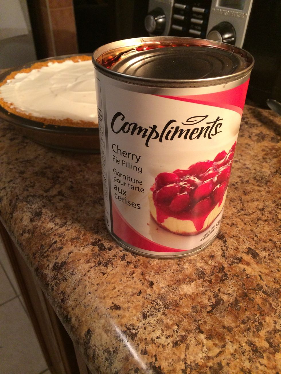 When you take the cake out you should be able to tell that the crust and filling has hardened a little bit. You will need cherry pie filling to top the cake. (Or any topping you want.)