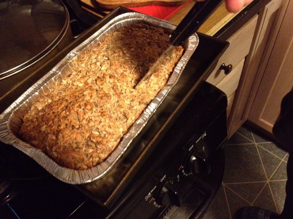 When you think it's done, test it by sticking a knife in. It should slide in relatively easily and come out dry. If it comes out with pieces of dough sticking to it, it's not done.