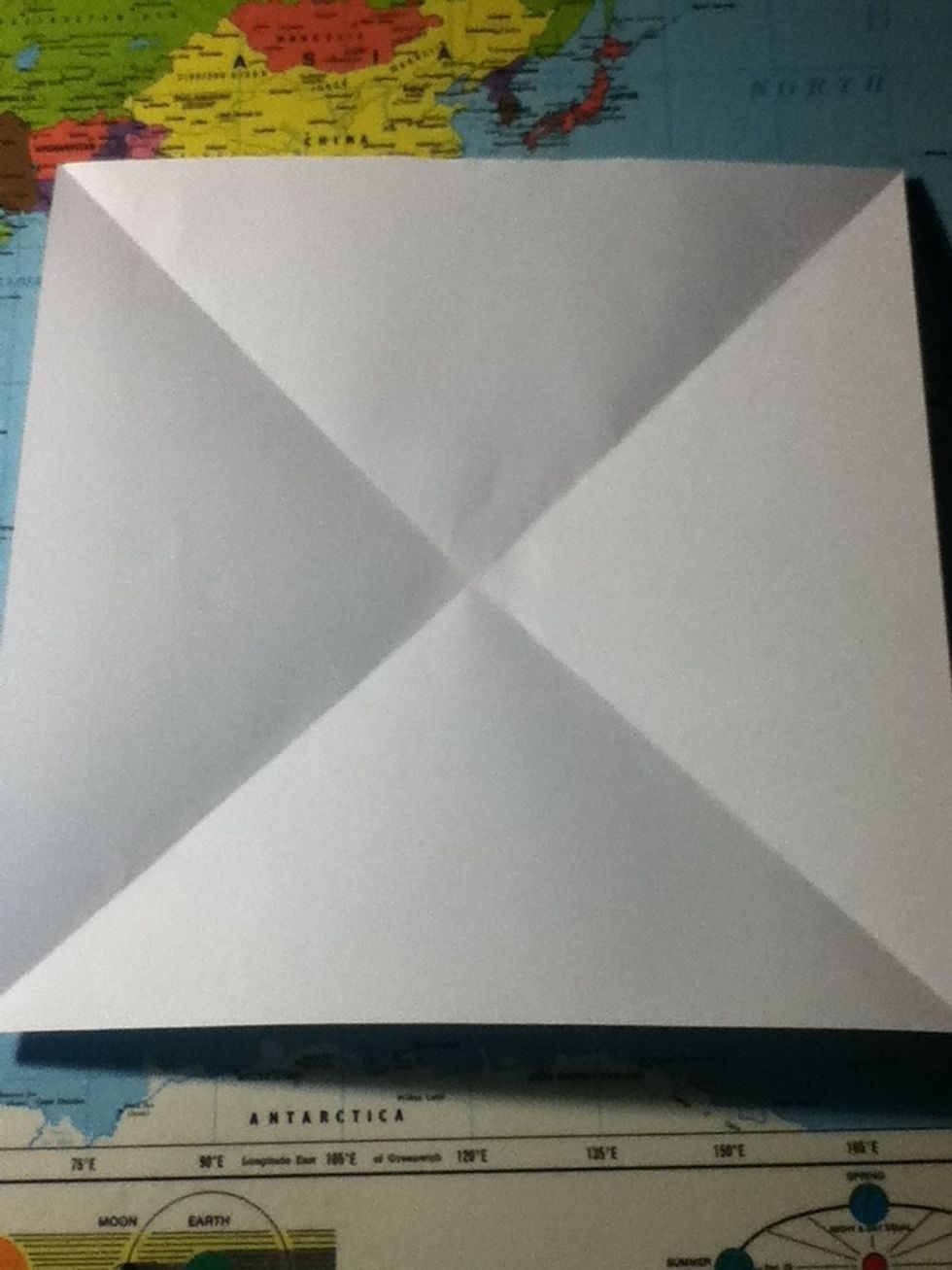 When you unfold it you should have a square with a cross on it