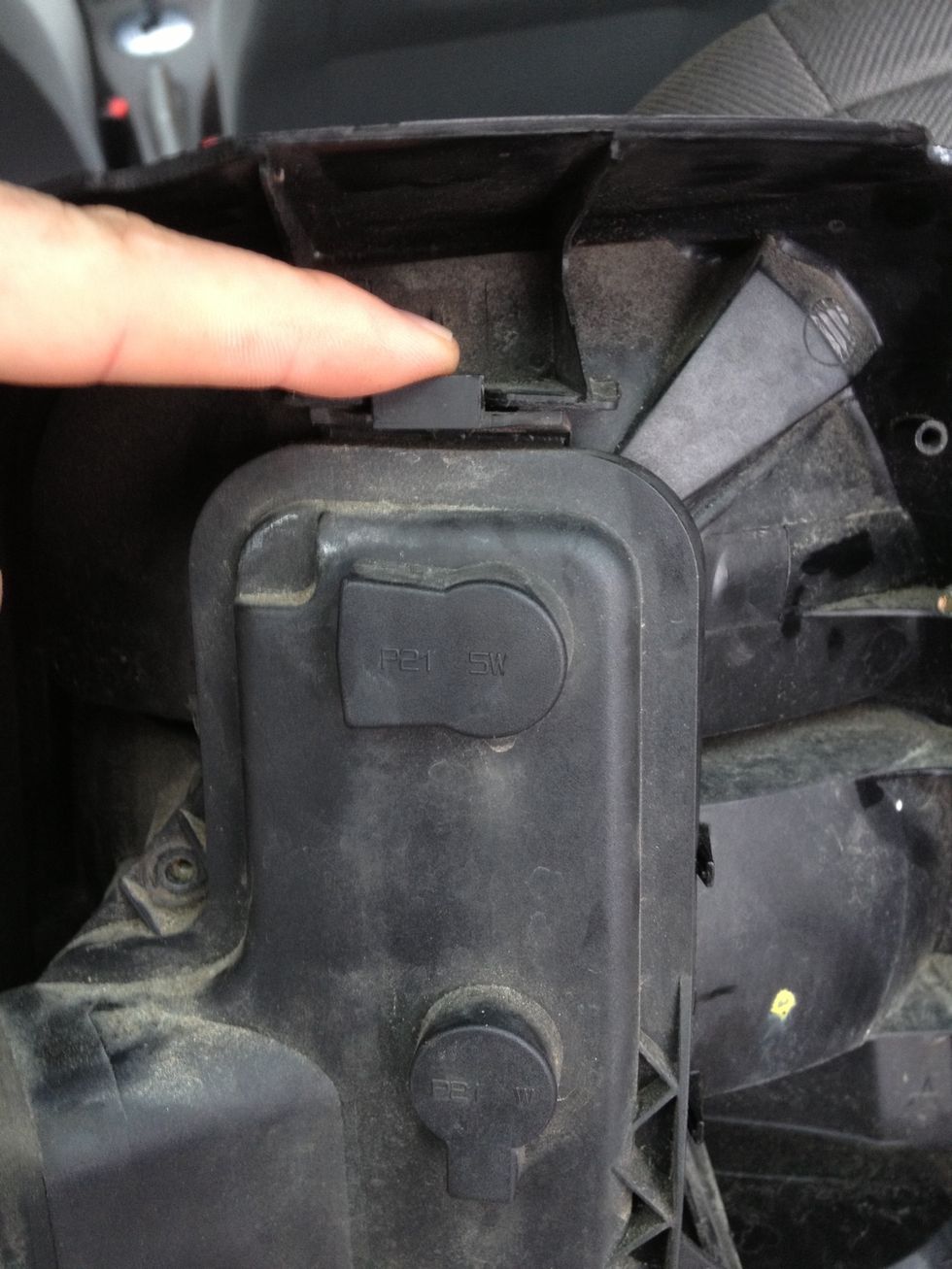 When you unscrewed the screws, open the casing with this handle on the top. Then you can hinge it open from the top and take the back of the casing off.