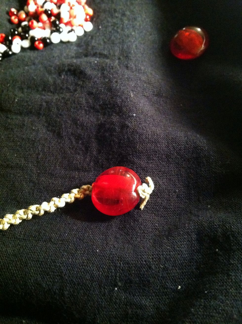 When you've reached a length of your choosing, add your large bead or button and tie it in securely. I usually measure by simply wrapping the bracelet around my wrist 3 times and seeing how it feels.