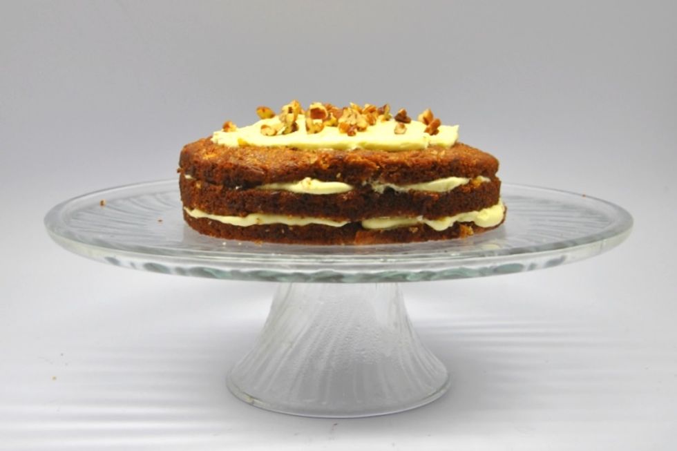 When you've reached the top, add more frosting than you did in the previous layers to give a fuller effect. Sprinkle pecans. (PS: I always refrigerate for another hour; so it sets before slicing)