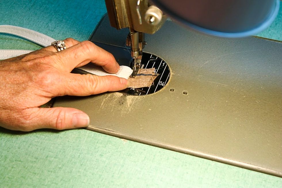 When you've successfully removed the zipper from the cushion cover - sew both the zipper stops back onto the zipper ends.  Whatever you do don't let the zipper to pull apart or let the slide slip off
