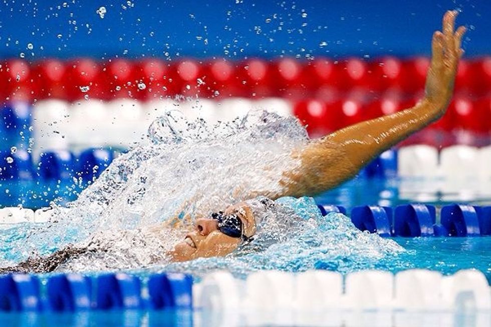 When your arms are out of the water, bring your arms in front of you. Keep your arms straight.