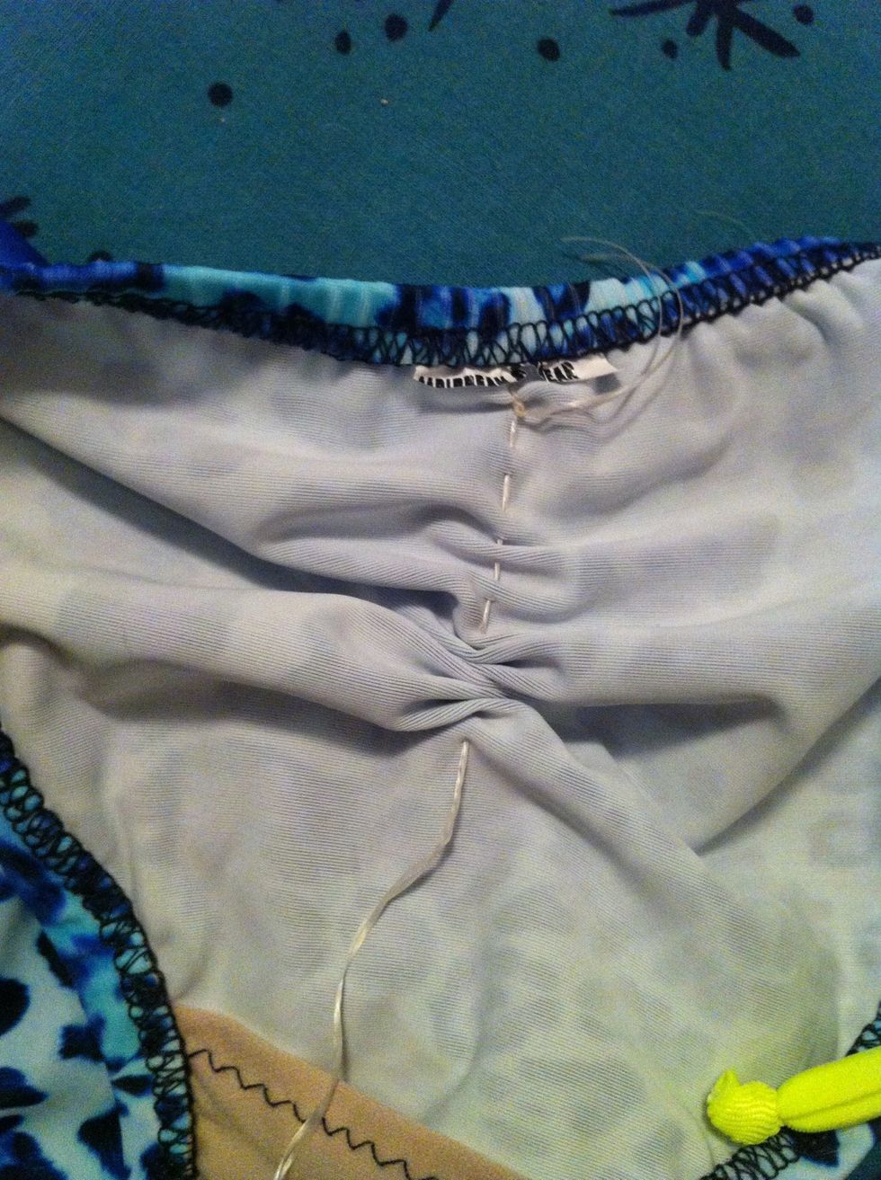 When your as low as you want, start scrunching the fabric up by pulling gently on the floss. Careful not to pull too hard and break the floss.