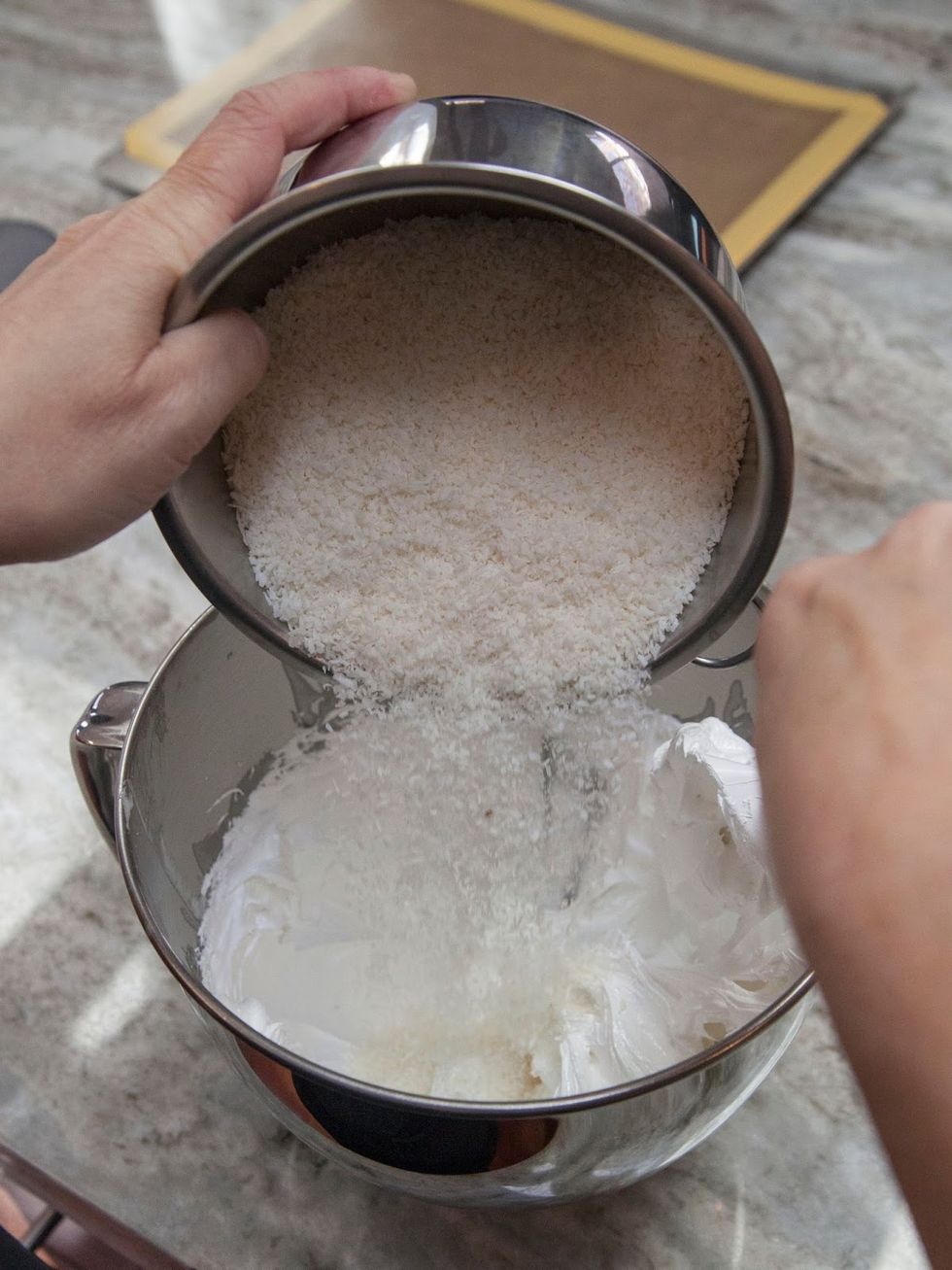 When your egg white sugar mixture is ready, add the shredded coconut.