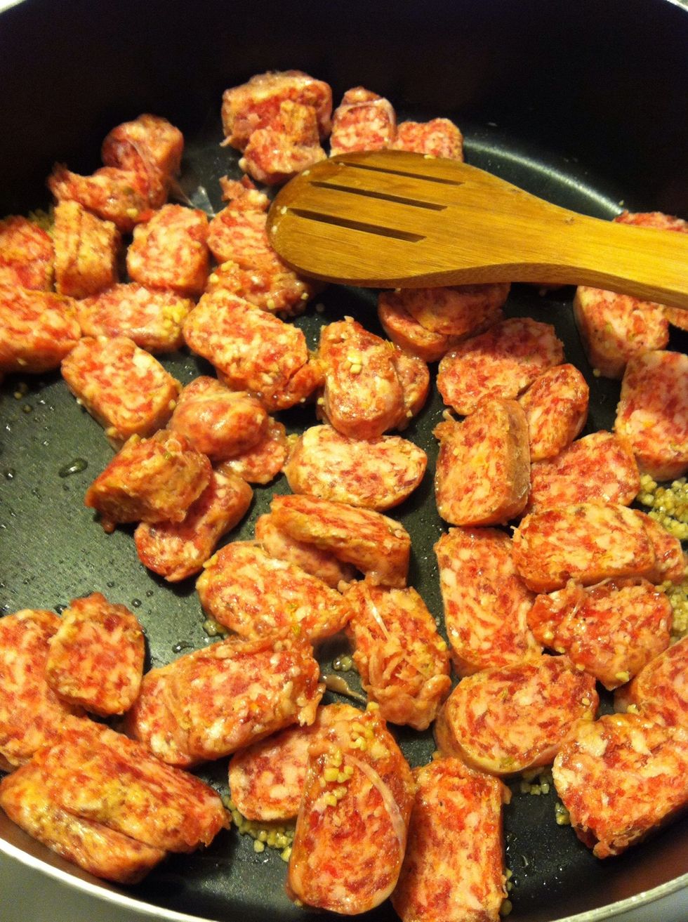 When your garlic begins to sizzle, toss your sausage in.