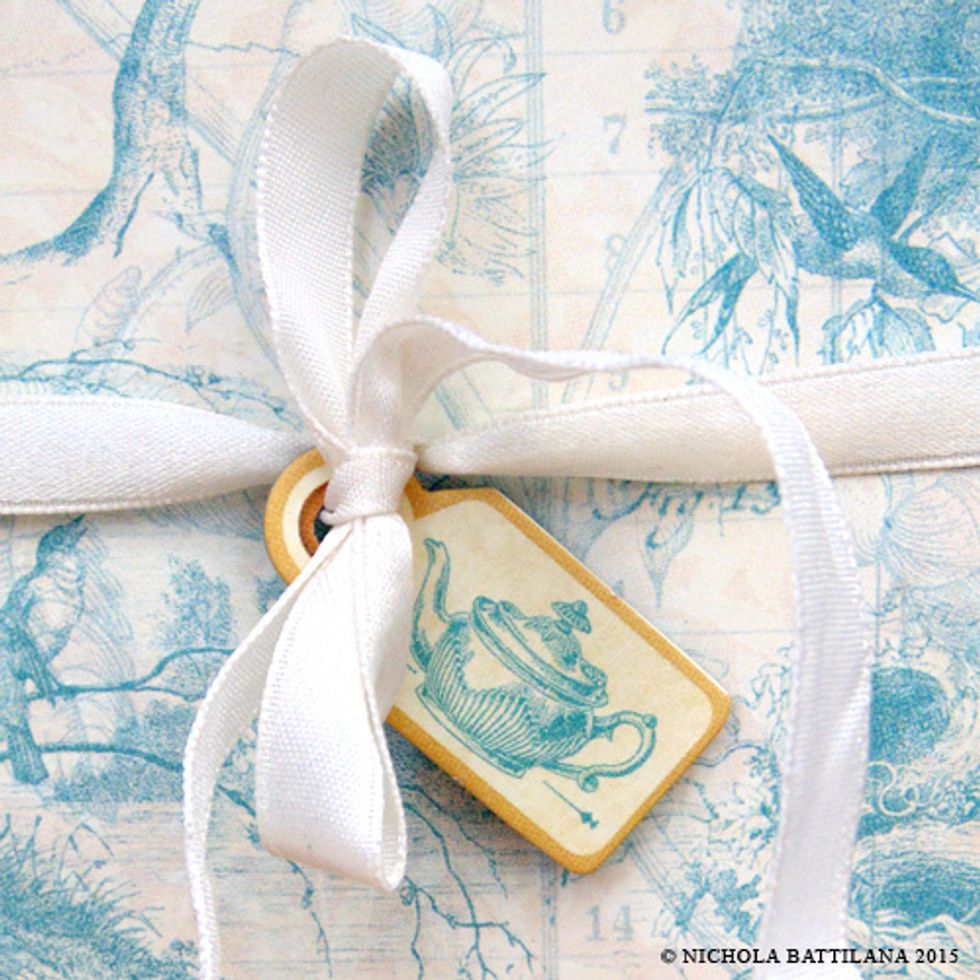 When your inside is complete, wrap the ribbon around the box, tie in a bow and add a pretty chipboard tag.