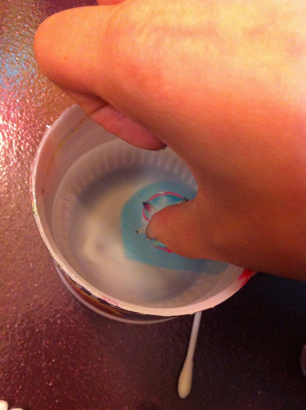 When your nails are dry, dip your finger in the middle, strait down, keep under water and with a toothpick collect the nail polish on the top of the water. Pull finger up